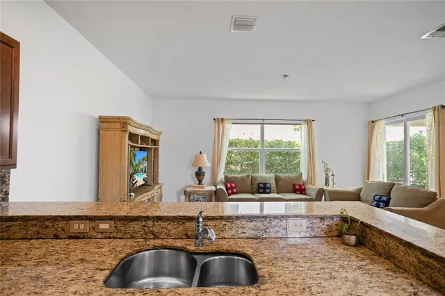 a living room with furniture wooden floor and a large window