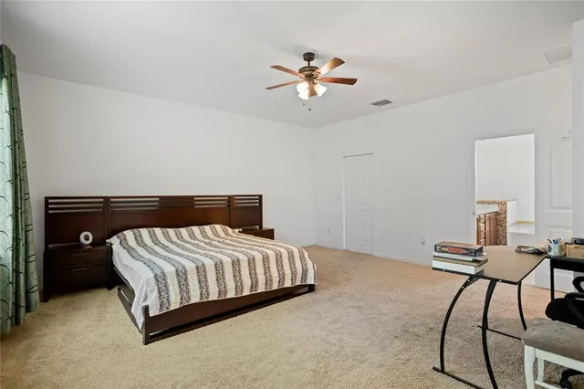 a bedroom with a bed and chandelier