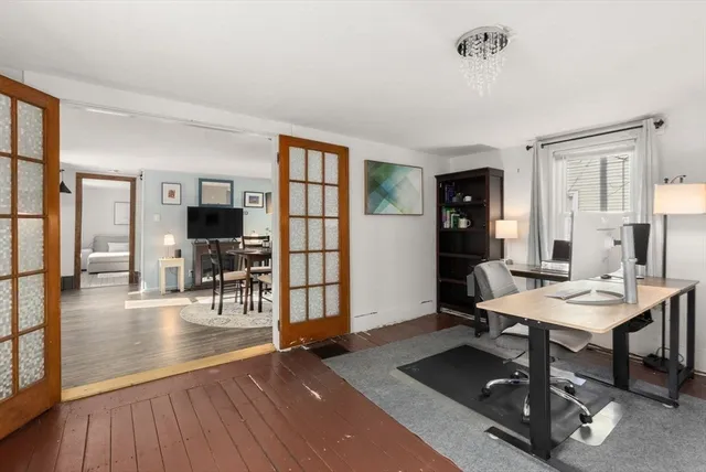 a view of a livingroom with workspace and a window