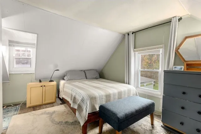 a bedroom with a bed and glass door