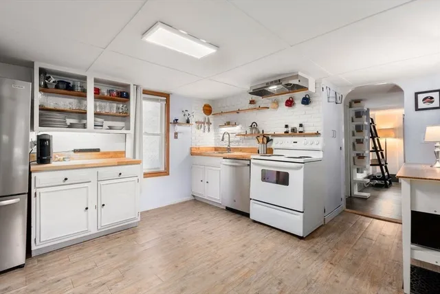 a kitchen with white cabinets and white appliances