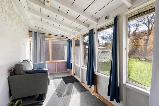 a backyard of a house with table and chairs