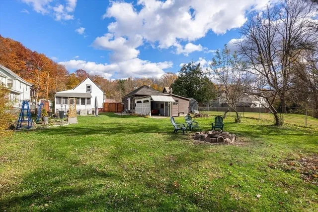 a view of a house with a yard and sitting area