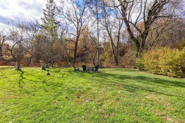a backyard of a house with table and chairs