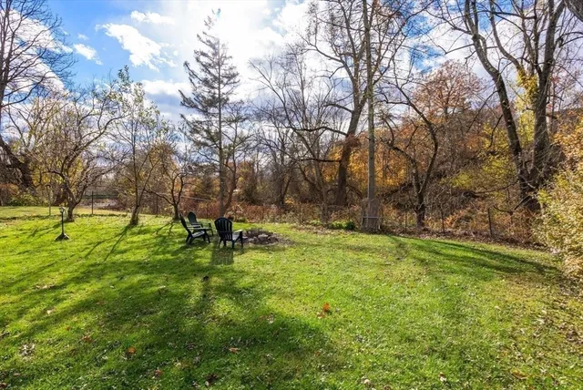 a view of a house with backyard and sitting area