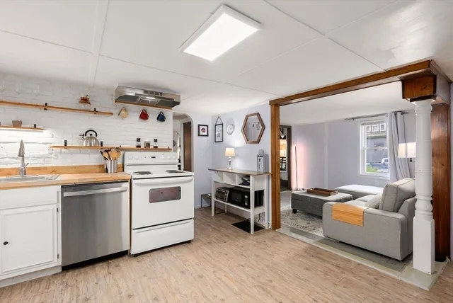 a kitchen with stainless steel appliances a stove a sink and a refrigerator