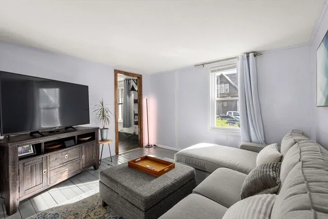 a view of a livingroom with furniture and a flat screen tv