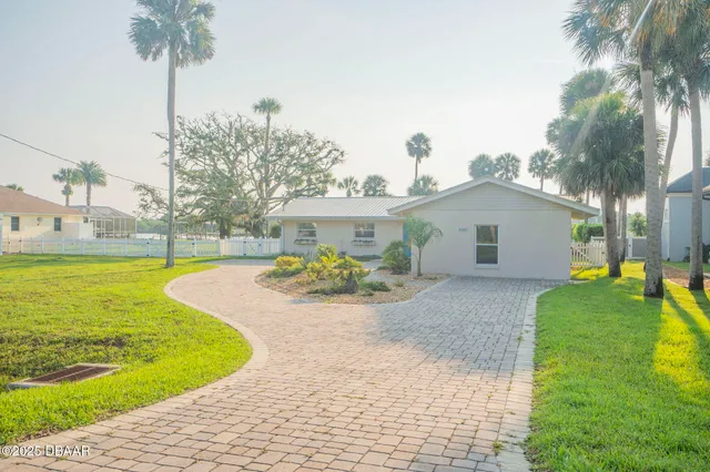a view of a house with swimming pool and a yard