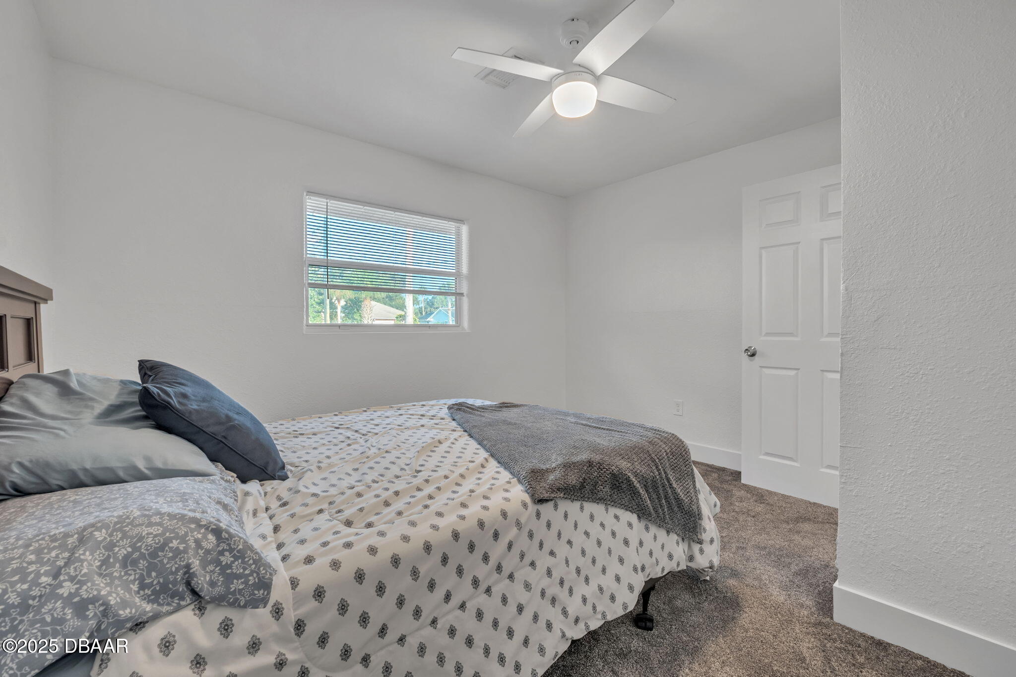 450 Lambert Avenue Flagler Beach, FL 32136 - Photo 21 of 47 a bedroom with a large bed and a window
