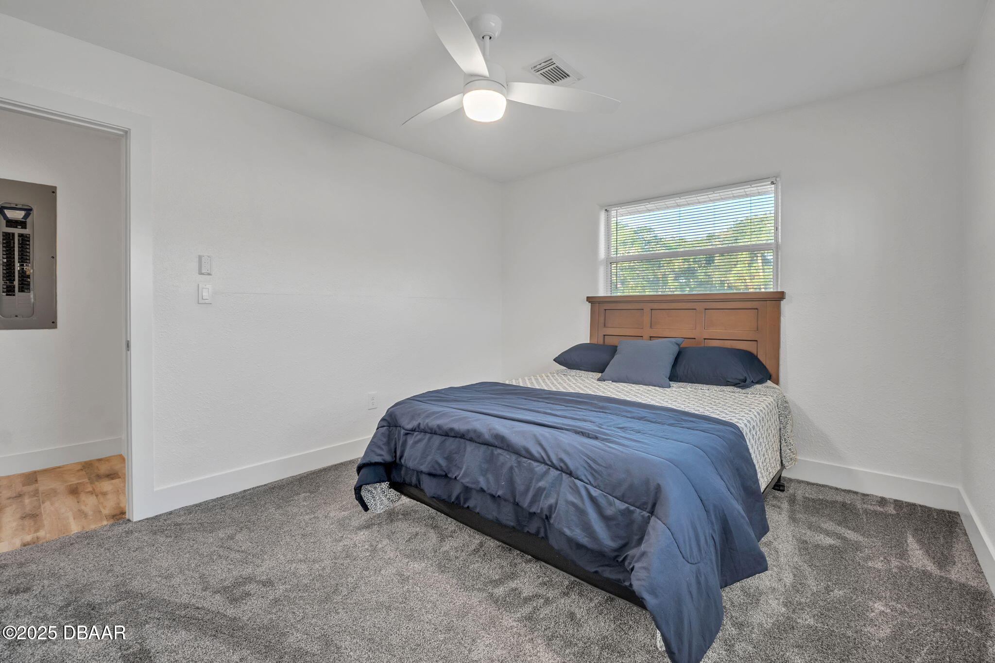 450 Lambert Avenue Flagler Beach, FL 32136 - Photo 25 of 47 a bedroom with a bed and a lamp