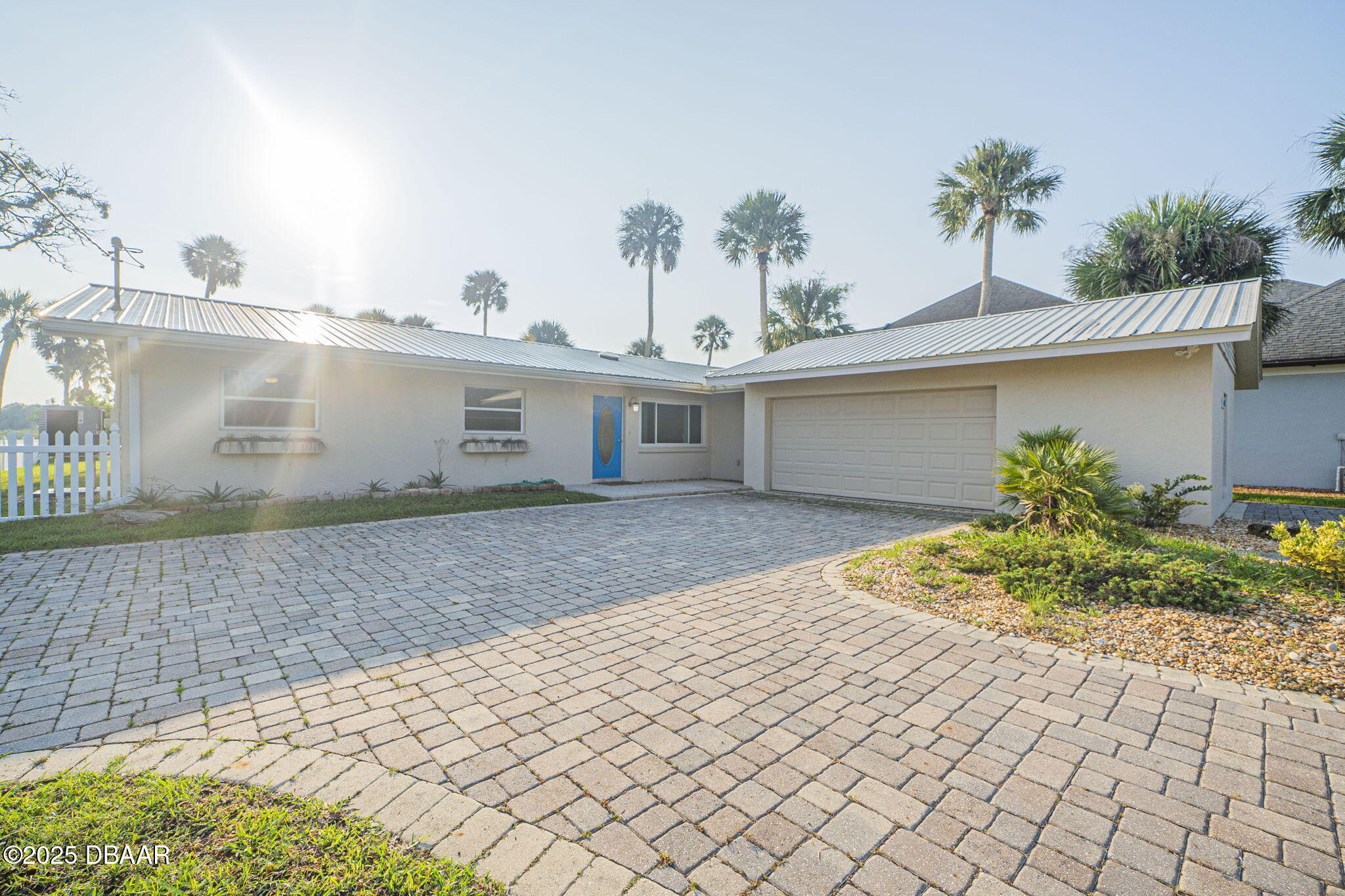 450 Lambert Avenue Flagler Beach, FL 32136 - Photo 4 of 47 a front view of a house with a yard and potted plants