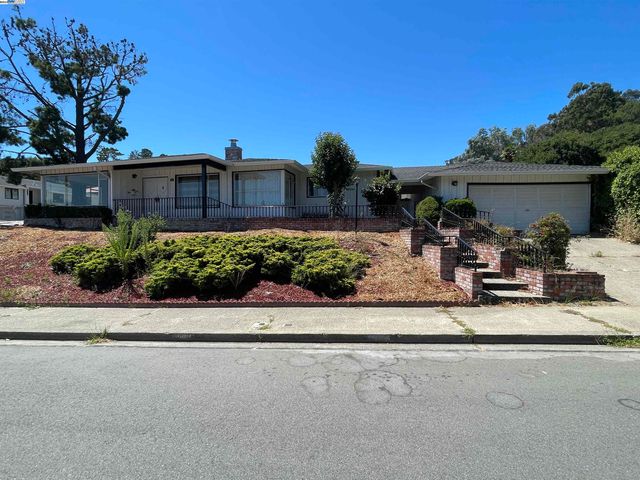 a view of a back yard with a table and chair and potted plants