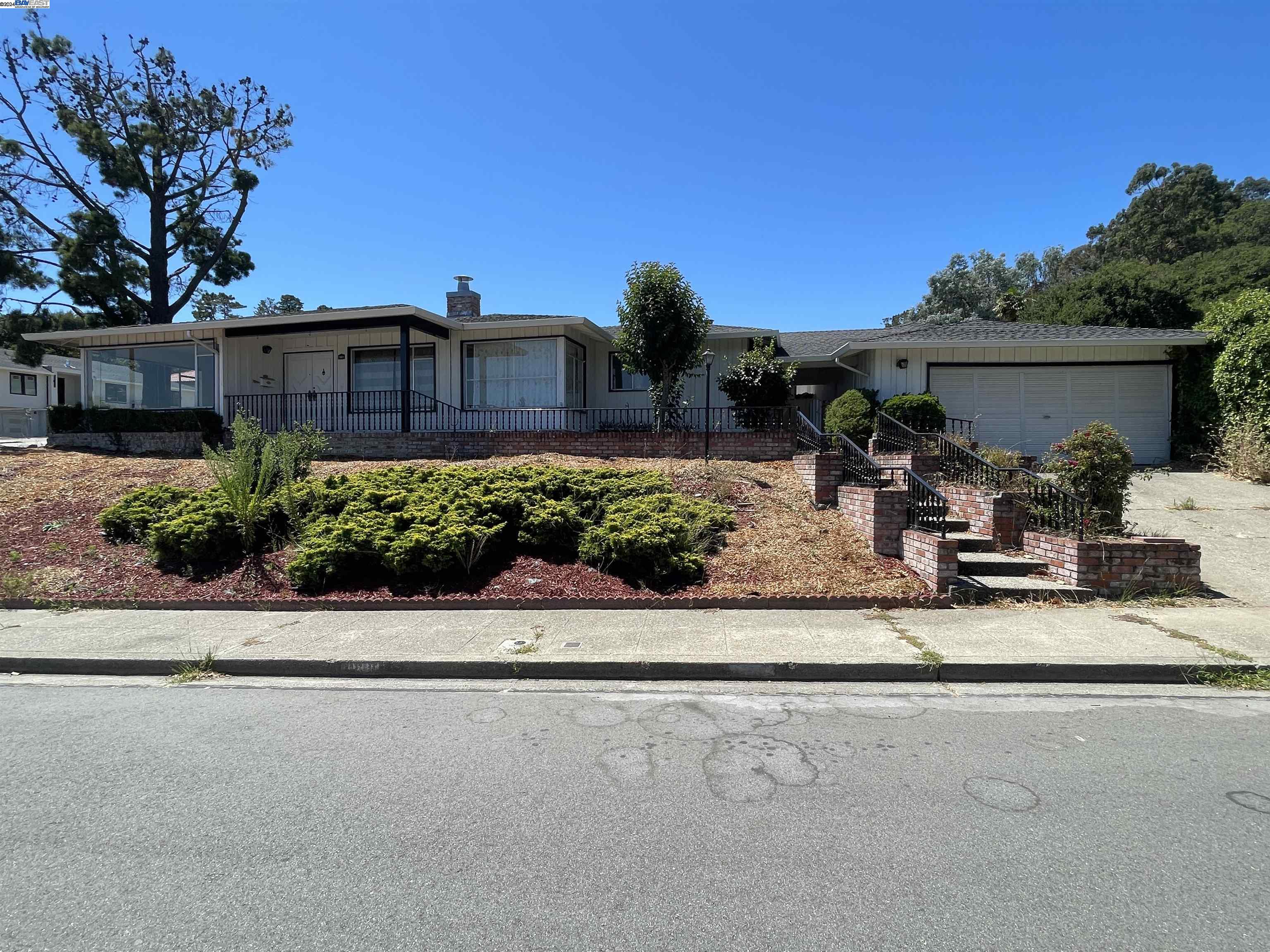 a view of a back yard with a table and chair and potted plants