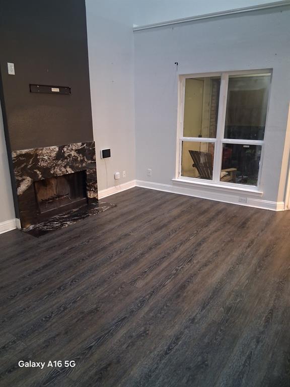 1501 East Interstate 30, Unit 223 Garland, TX 75043 - Photo 13 of 19 an empty room with wooden floor and windows
