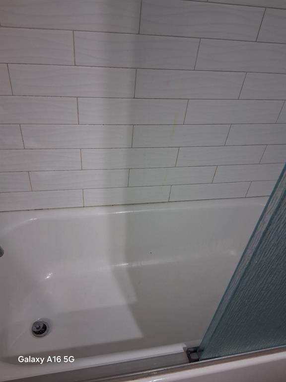 1501 East Interstate 30, Unit 223 Garland, TX 75043 - Photo 16 of 19 a bathroom with a bathtub