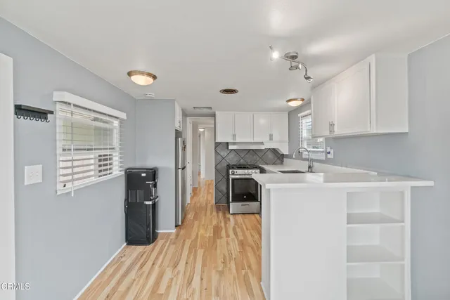 a kitchen with a refrigerator a stove and a cabinets