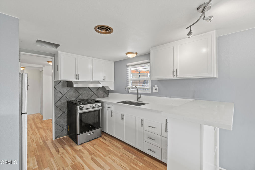 7368 Hollister Avenue, Unit 28 Goleta, CA 93117 - Photo 15 of 33 a kitchen with stainless steel appliances granite countertop a stove and a sink