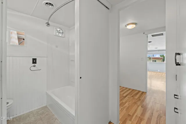 a bathroom with a bathtub and shower