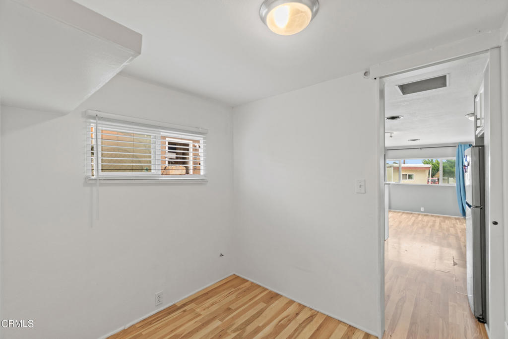 7368 Hollister Avenue, Unit 28 Goleta, CA 93117 - Photo 20 of 33 a view of a hallway with wooden floor and a bathroom