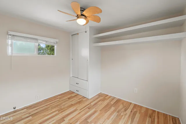 a view of a room with wooden floor