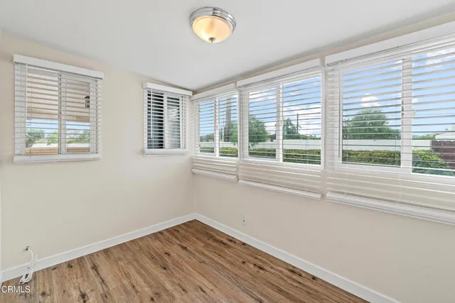 a view of wooden floor and windows in a room