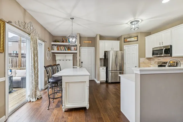 a spacious bathroom with a granite countertop sink a large mirror a toilet and a bathtub