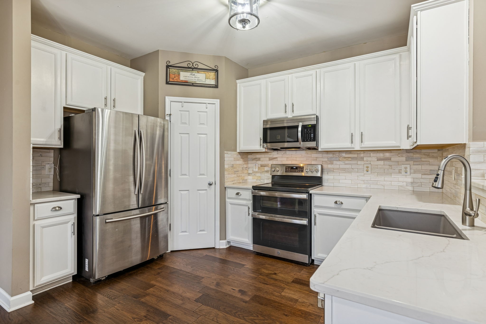 4028 Williford Way Spring Hill, TN 37174 - Photo 31 of 70 a kitchen with granite countertop a refrigerator stove and microwave