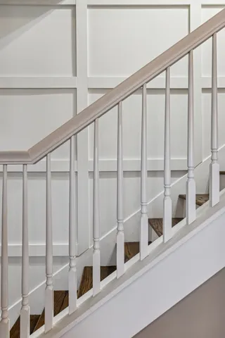 a spacious bedroom with a bed and a chandelier