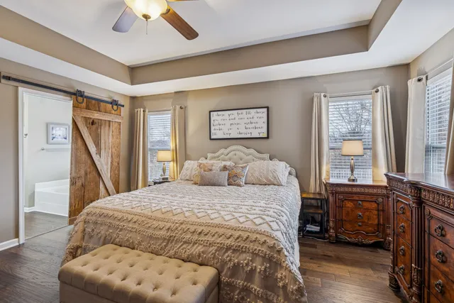 a bedroom with a large bed and a flat screen tv