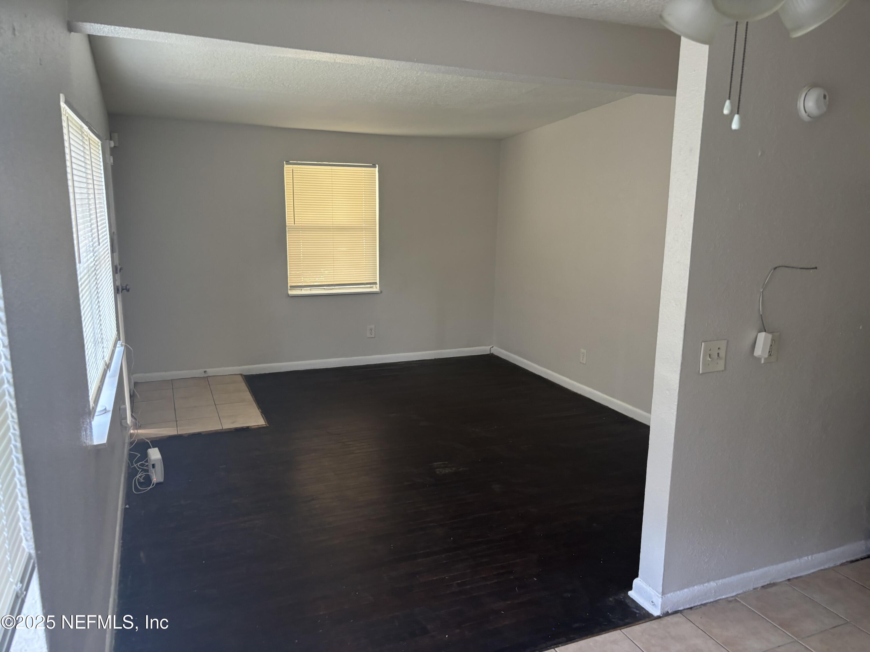4225 Homer Road North Jacksonville, FL 32209 - Photo 5 of 11 wooden floor in an empty room with a window