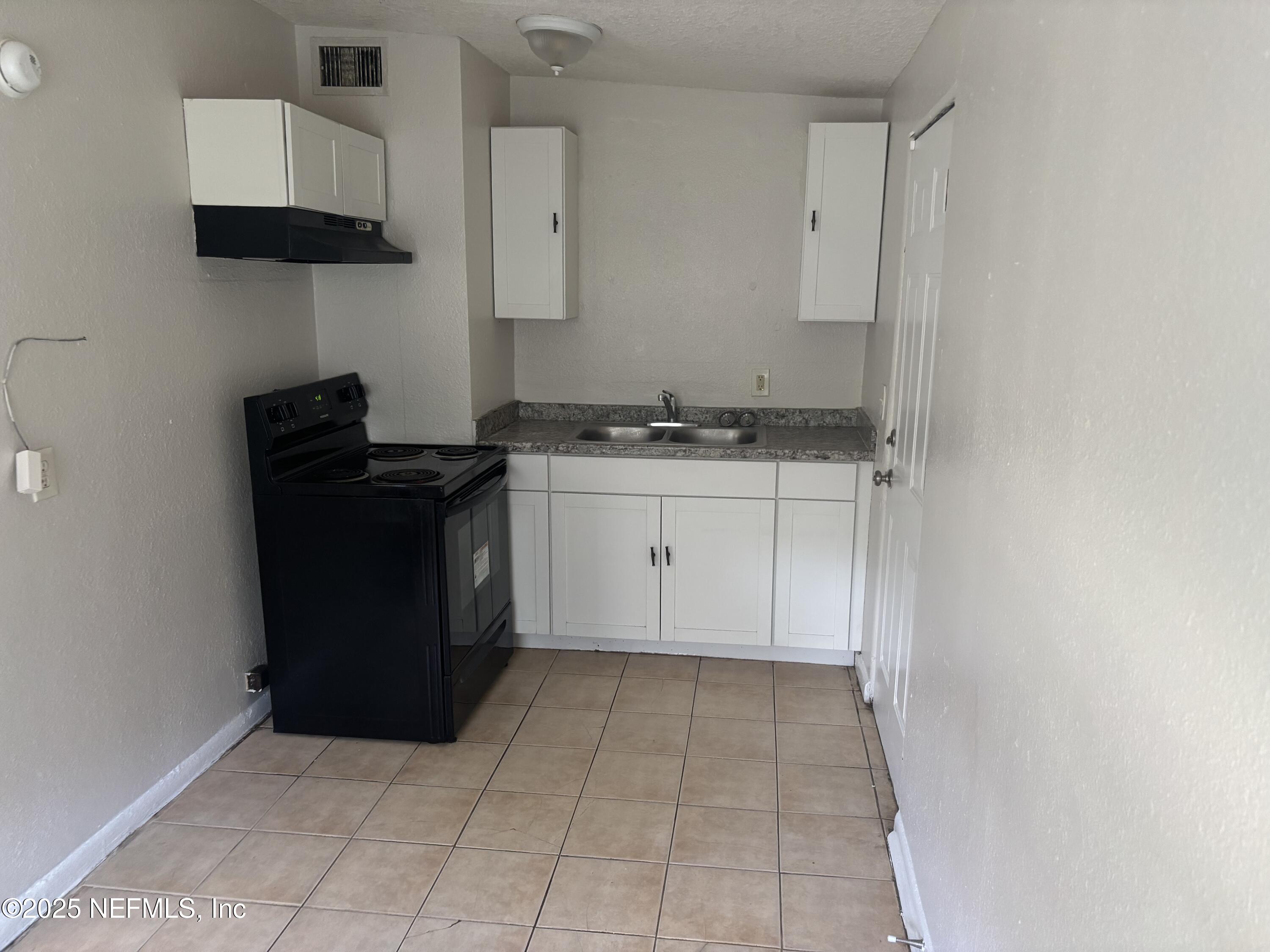 4225 Homer Road North Jacksonville, FL 32209 - Photo 7 of 11 a kitchen with a sink and a stove