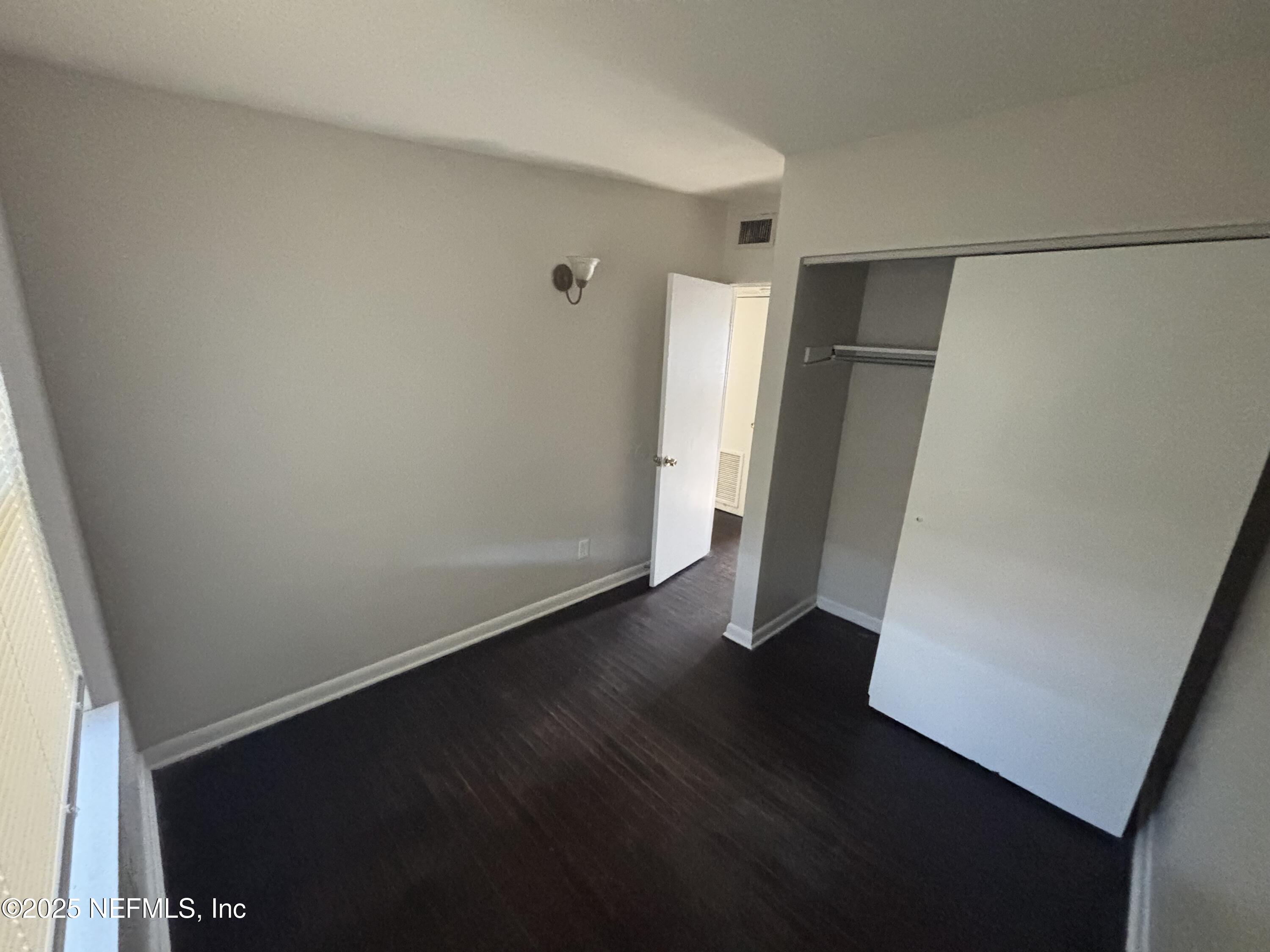 4225 Homer Road North Jacksonville, FL 32209 - Photo 9 of 11 an empty room with wooden floor and closet