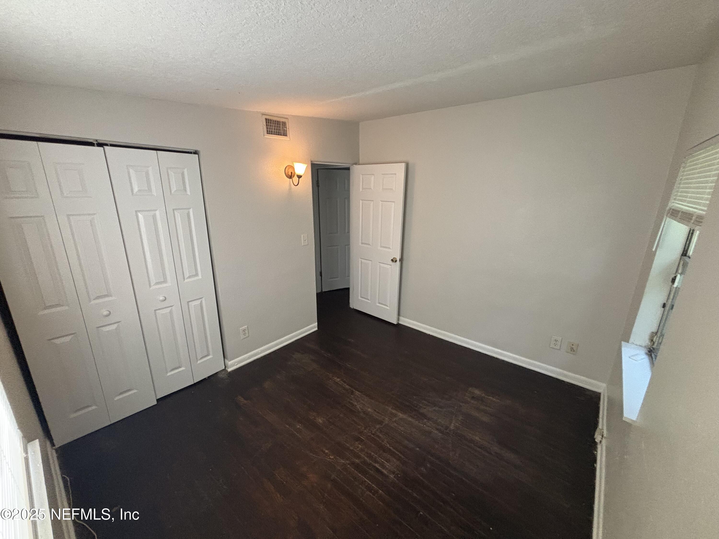 4225 Homer Road North Jacksonville, FL 32209 - Photo 10 of 11 an empty room with wooden floor and windows