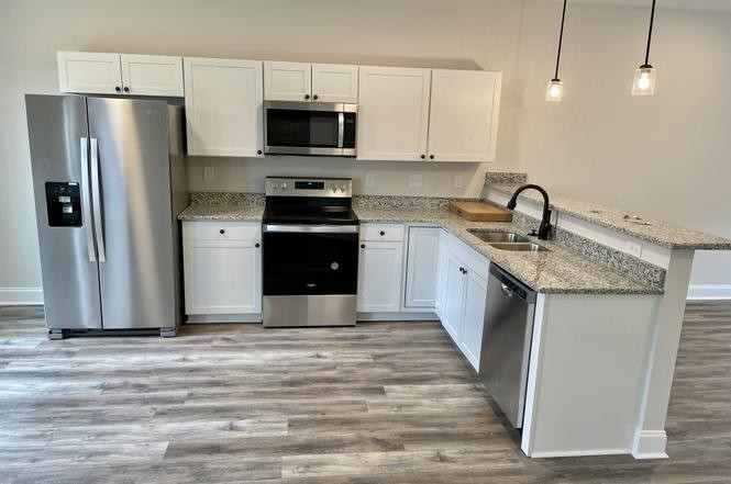 500 Peachers Mill Road, Unit C2 Clarksville, TN 37042 - Photo 6 of 16 a kitchen with stainless steel appliances granite countertop a refrigerator stove microwave and sink