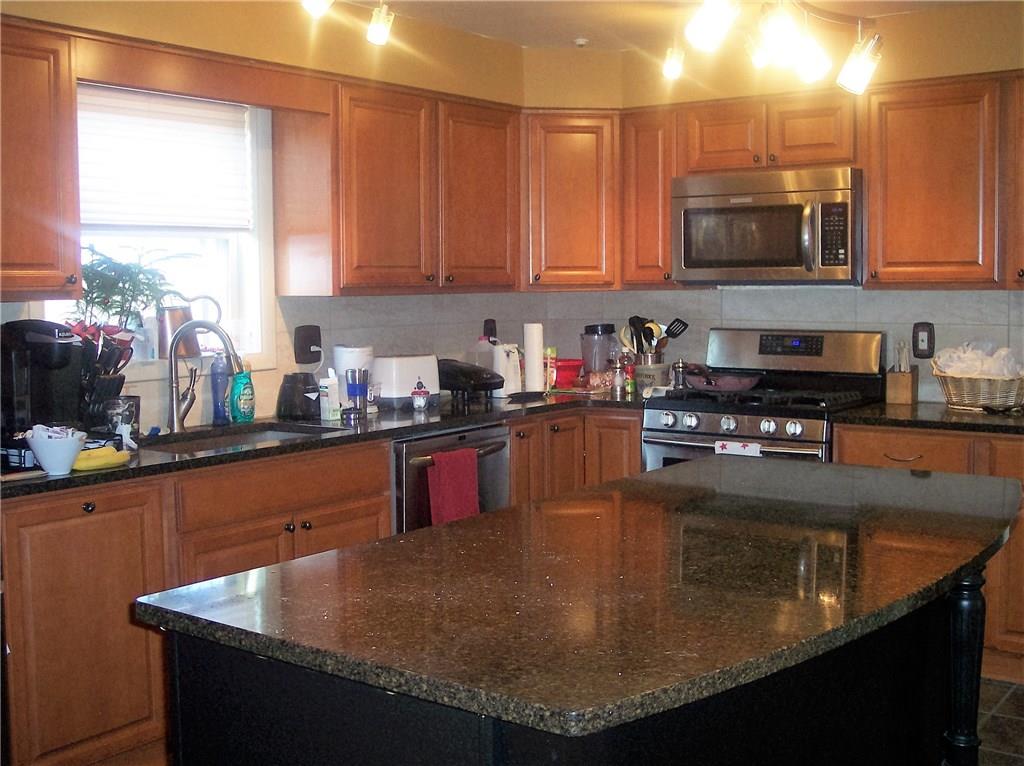 206 Ridgeview Drive Wexford, PA 15090 - Photo 2 of 12 Updated Kitchen with Quartz counter-tops, center isle w/ drawers, gas stove, dishwasher,convection oven, and convection/microwave. Lots of cabinets.
