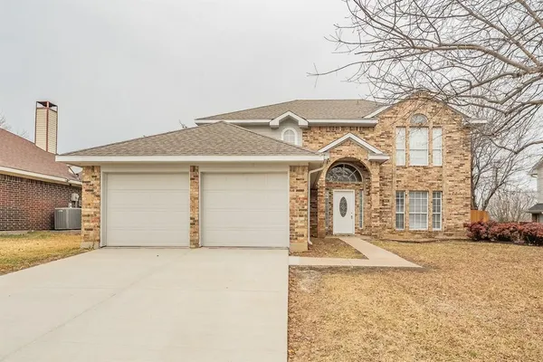 a view of a white house with a yard and garage