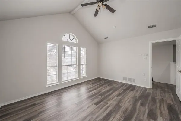 a view of a room with wooden floor and white walls