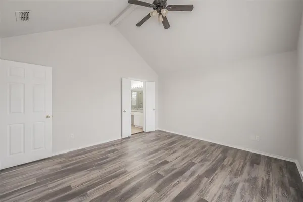 a spacious bathroom with a granite countertop sink a mirror and a bathtub