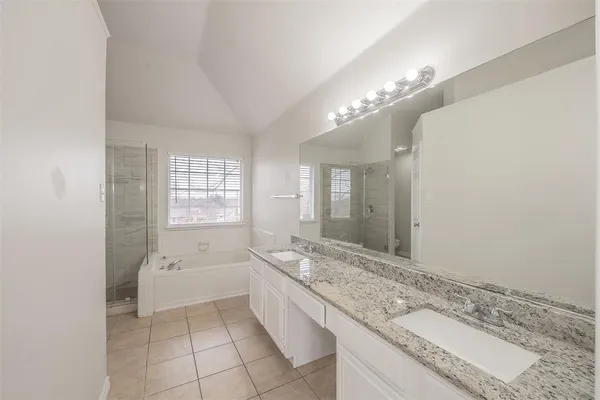 a white bath tub sitting next to a shower