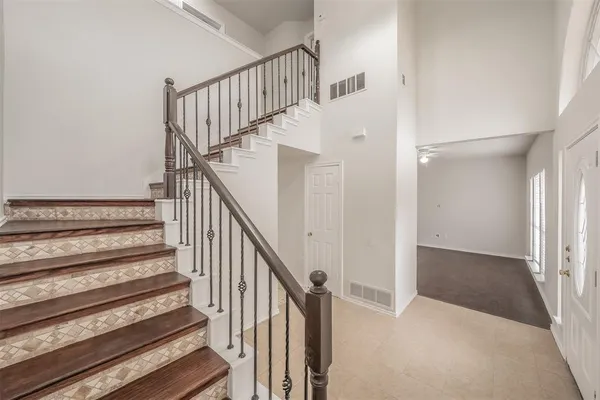 a view of staircase with wooden floor and white walls