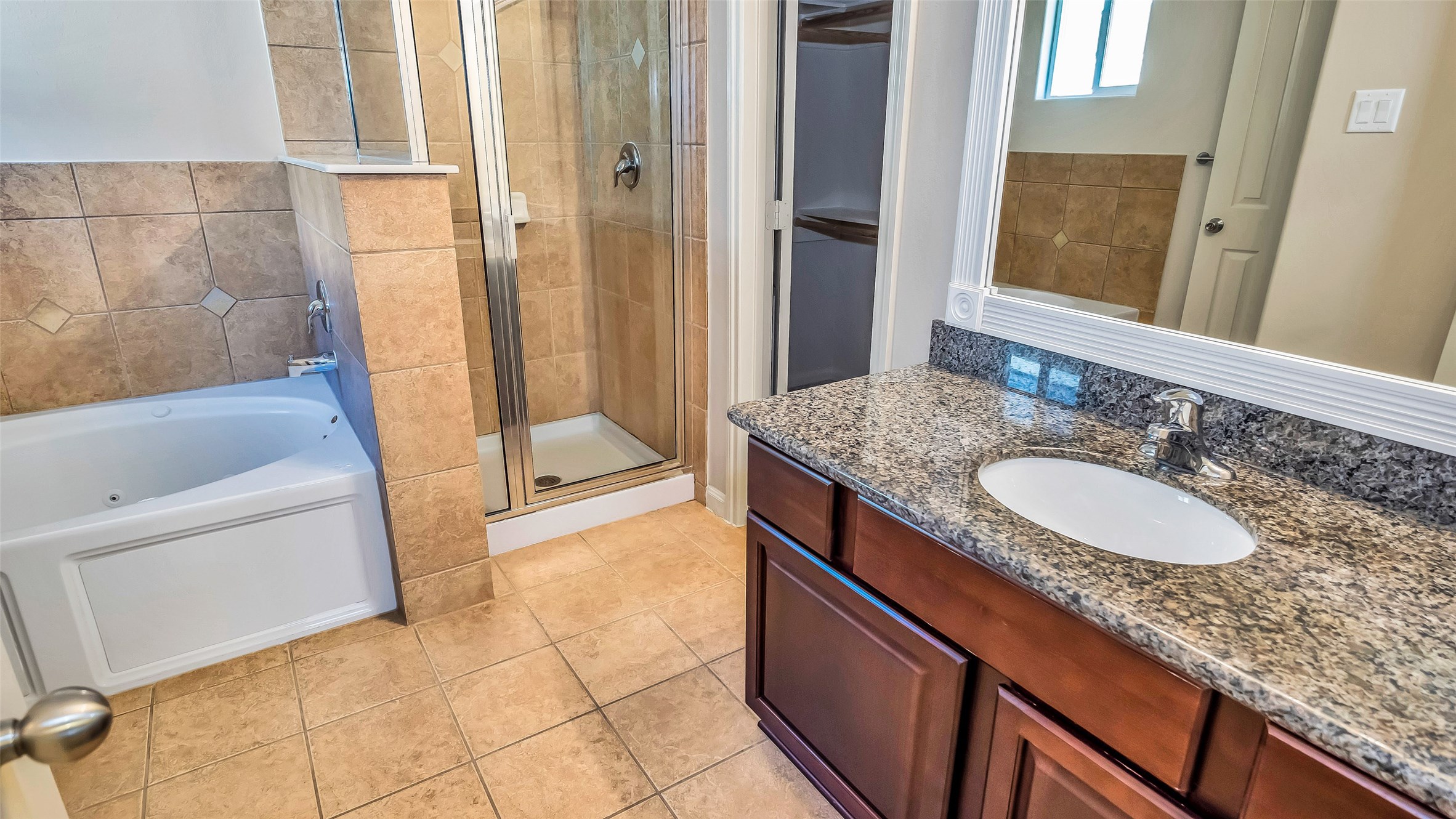 1724 Don Alejandro Houston, TX 77091 - Photo 17 of 32 a bathroom with a granite countertop sink a mirror and a bathtub