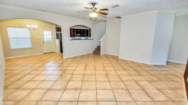 a view of a bathroom with a bathtub and a chandelier fan