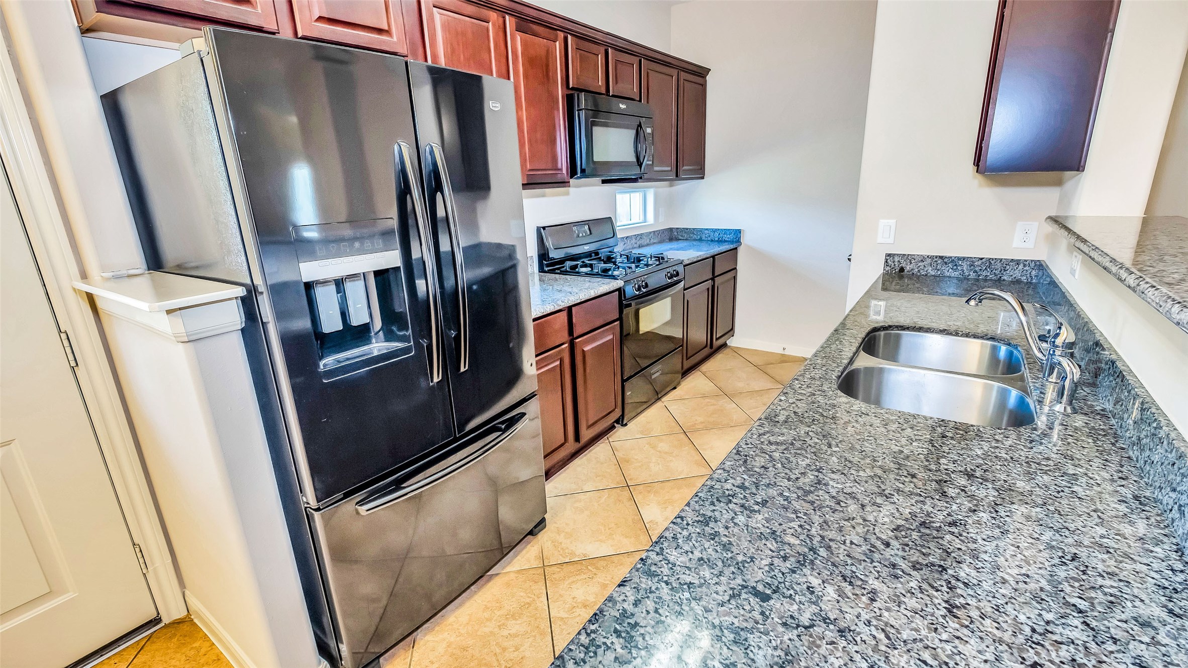 1724 Don Alejandro Houston, TX 77091 - Photo 9 of 32 a kitchen with stainless steel appliances granite countertop a refrigerator and a stove