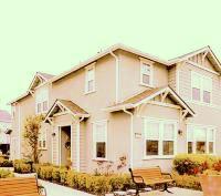 a view of a white house with large windows