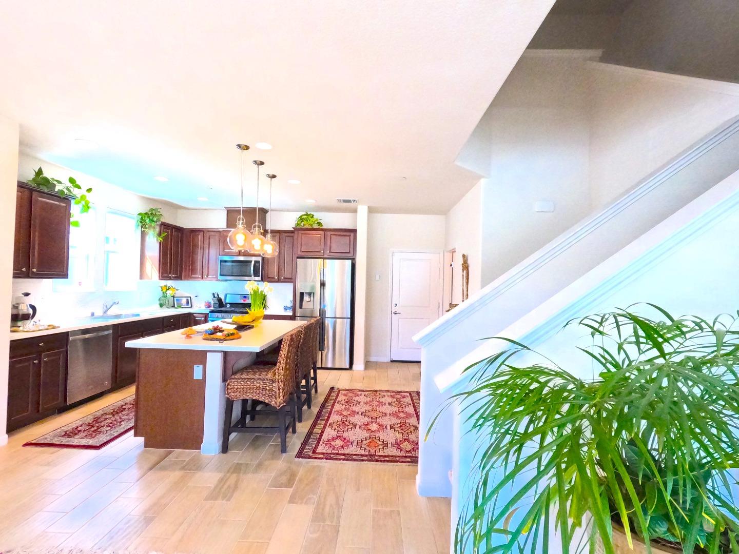 13217 Thomas Lane Marina, CA 93933 - Photo 11 of 35 a kitchen with stainless steel appliances granite countertop a stove a sink dishwasher and cabinets with wooden floor