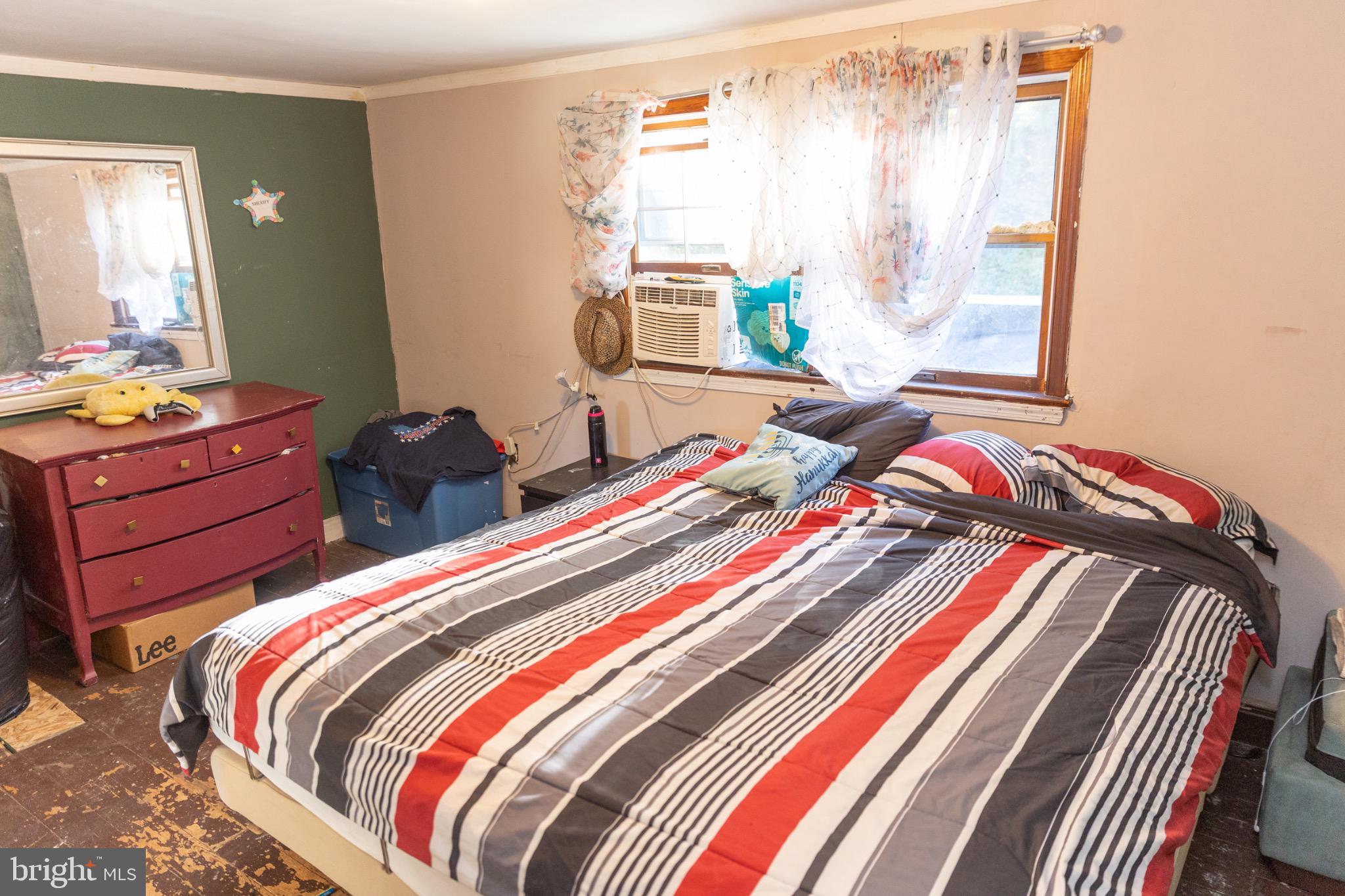 231 Laurel Street Minersville, PA 17954 - Photo 18 of 22 Cozy bedroom with vibrant striped bedding.