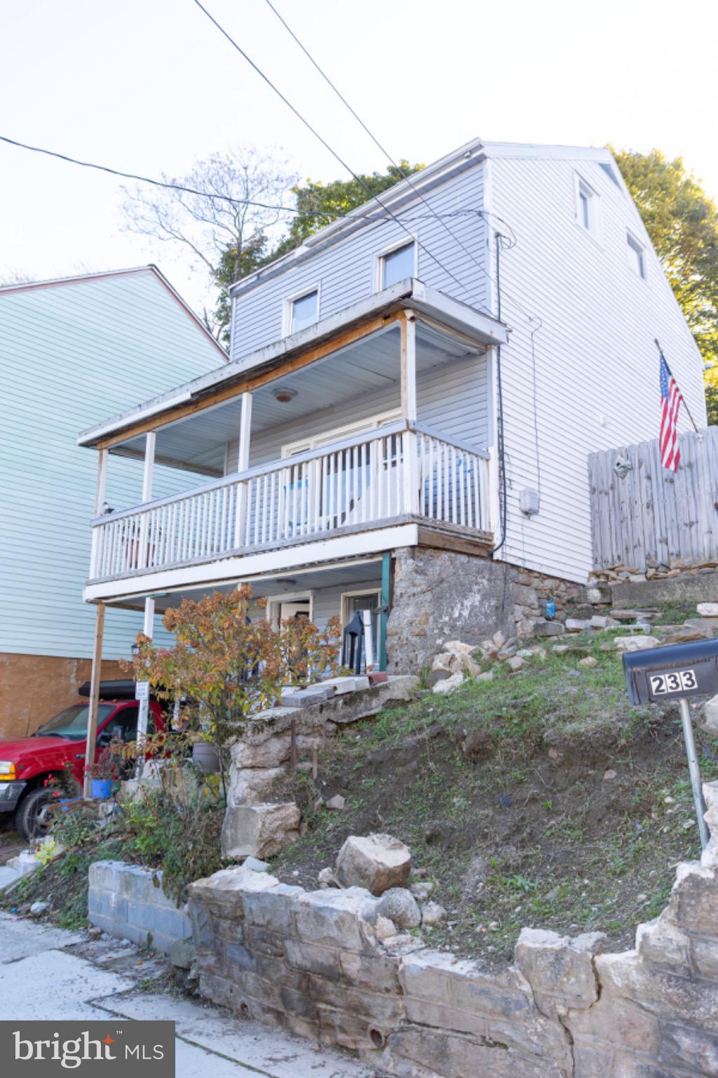 231 Laurel Street Minersville, PA 17954 - Photo 2 of 22 Charming home with inviting porch and greenery.