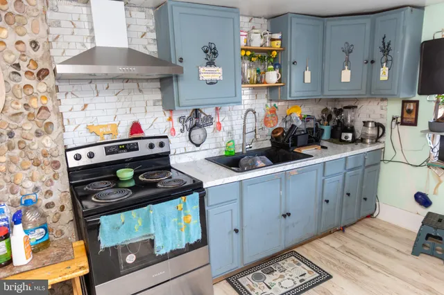 a kitchen with stainless steel appliances a stove and cabinets