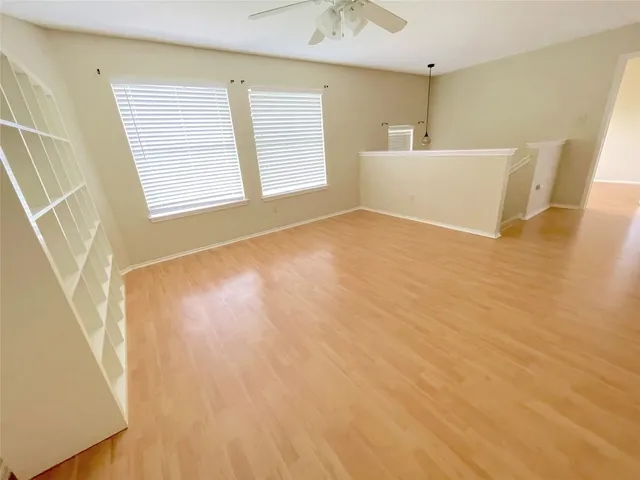 a view of a room with wooden floor and cabinet