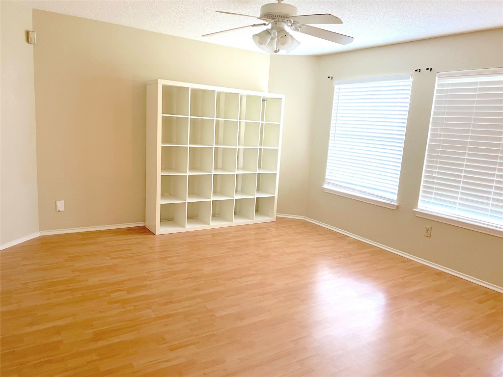 8501 Bismark Cove Austin, TX 78745 - Photo 12 of 24 a view of an empty room with a window and wooden floor